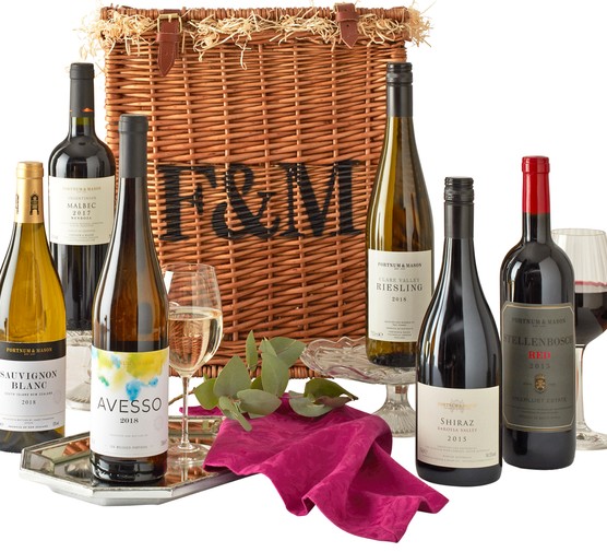 Wine hamper with bottles and glasses laid out