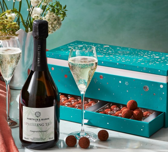 A bottle of sparkling tea and a big box filled with Fortnum's chocolate truffles