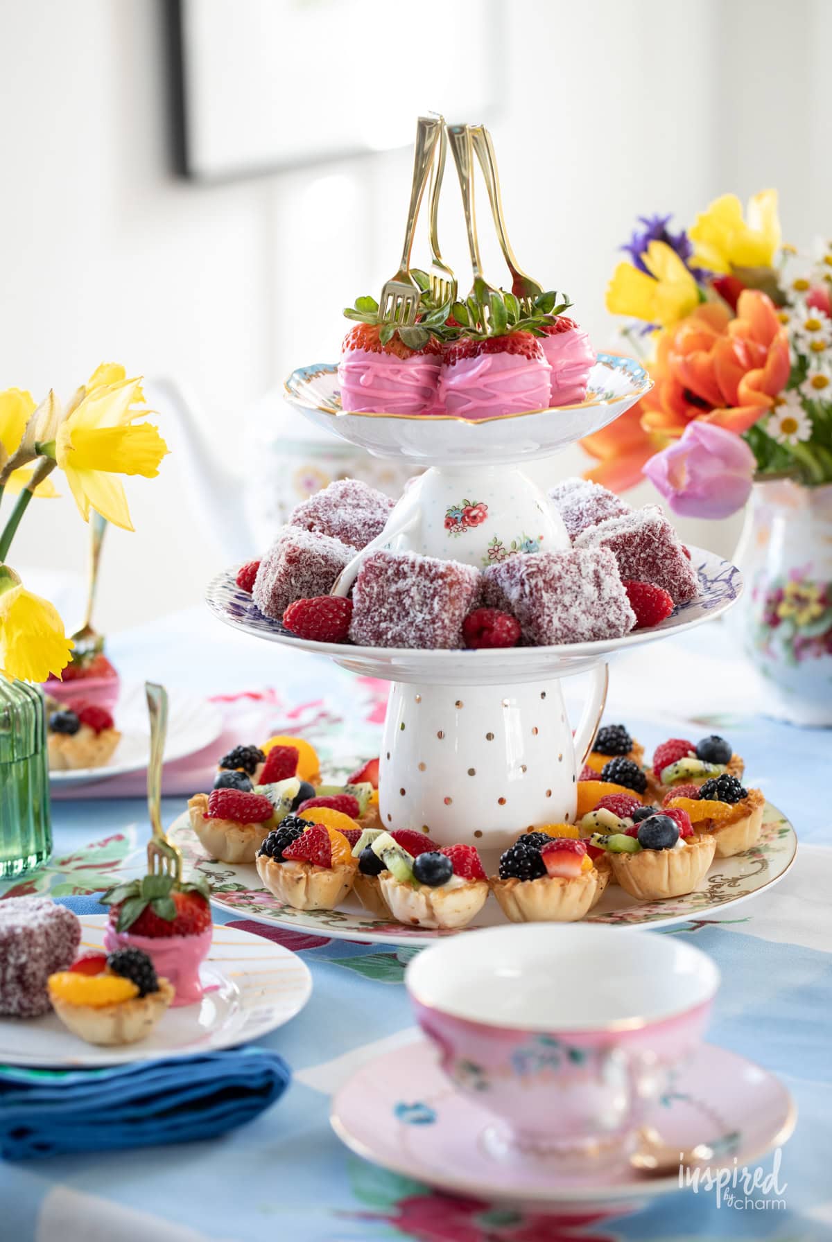 afternoon tea with tiered serving tray filled with colorful desserts.