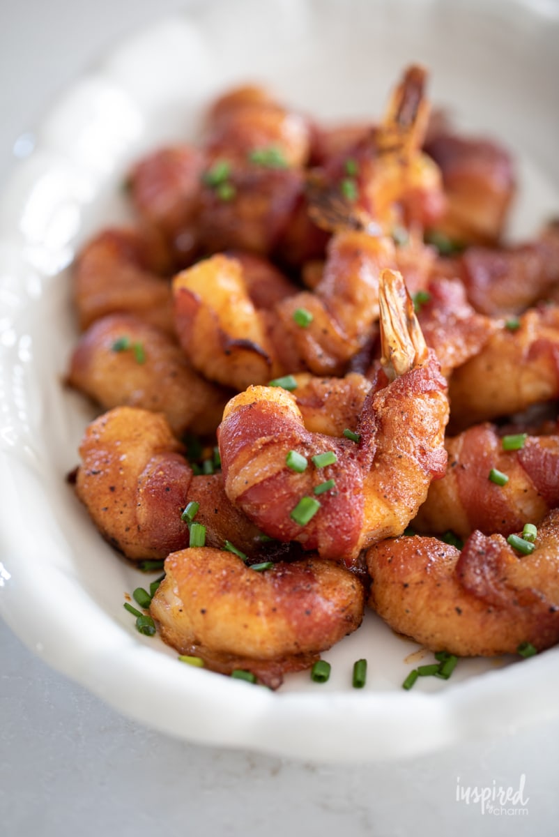 crispy bacon wrapped shrimp on a platter