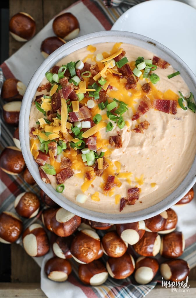 Beer Cheese Dip with Bacon served in a bowl with pretzel bites. 