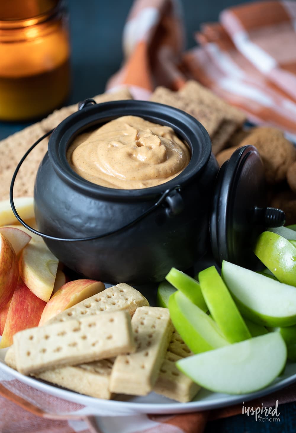 pumpkin dip in bowl with apples and cookies.