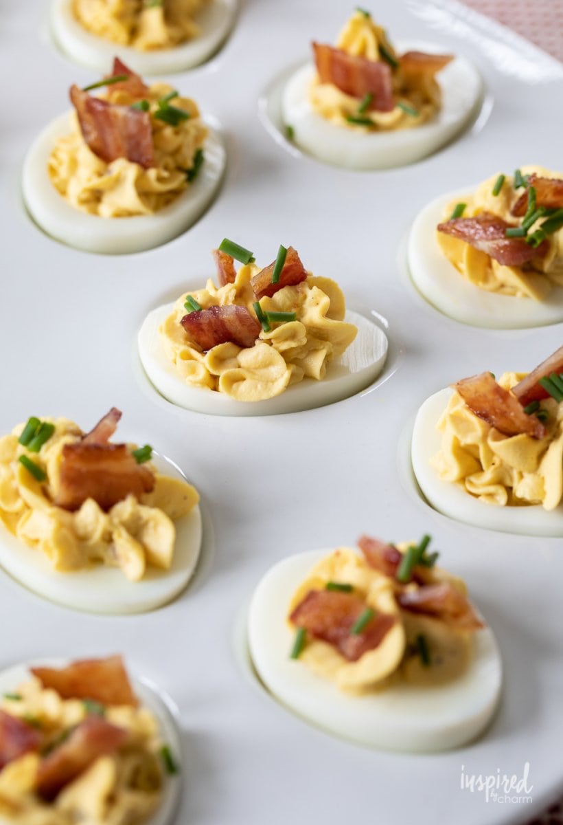 deviled eggs with bacon on a plate