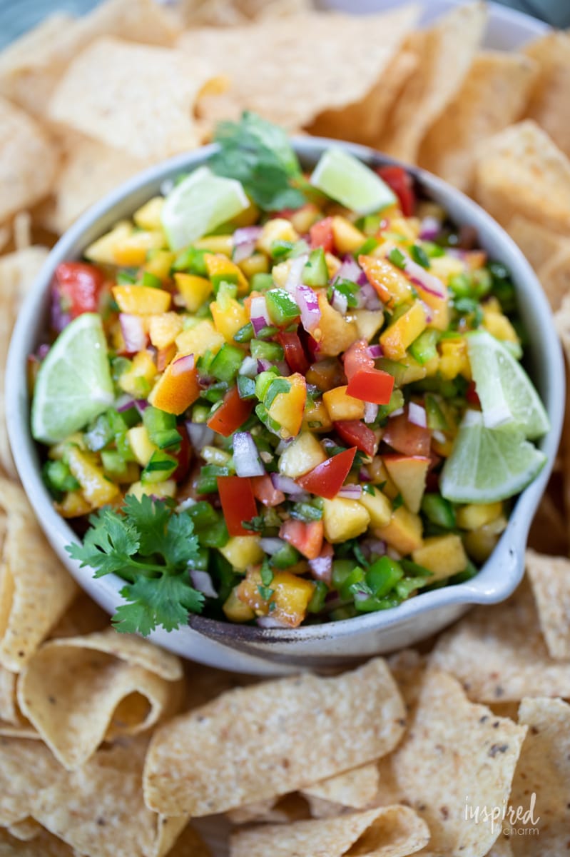 Spicy Peach Salsa in a bowl with tortilla chips.