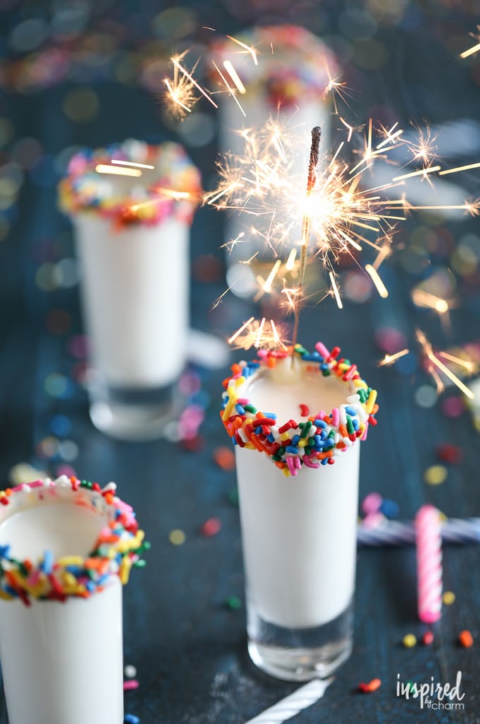 shot glass rimmed with sprinkles filled with a birthday cake flavored shot. 