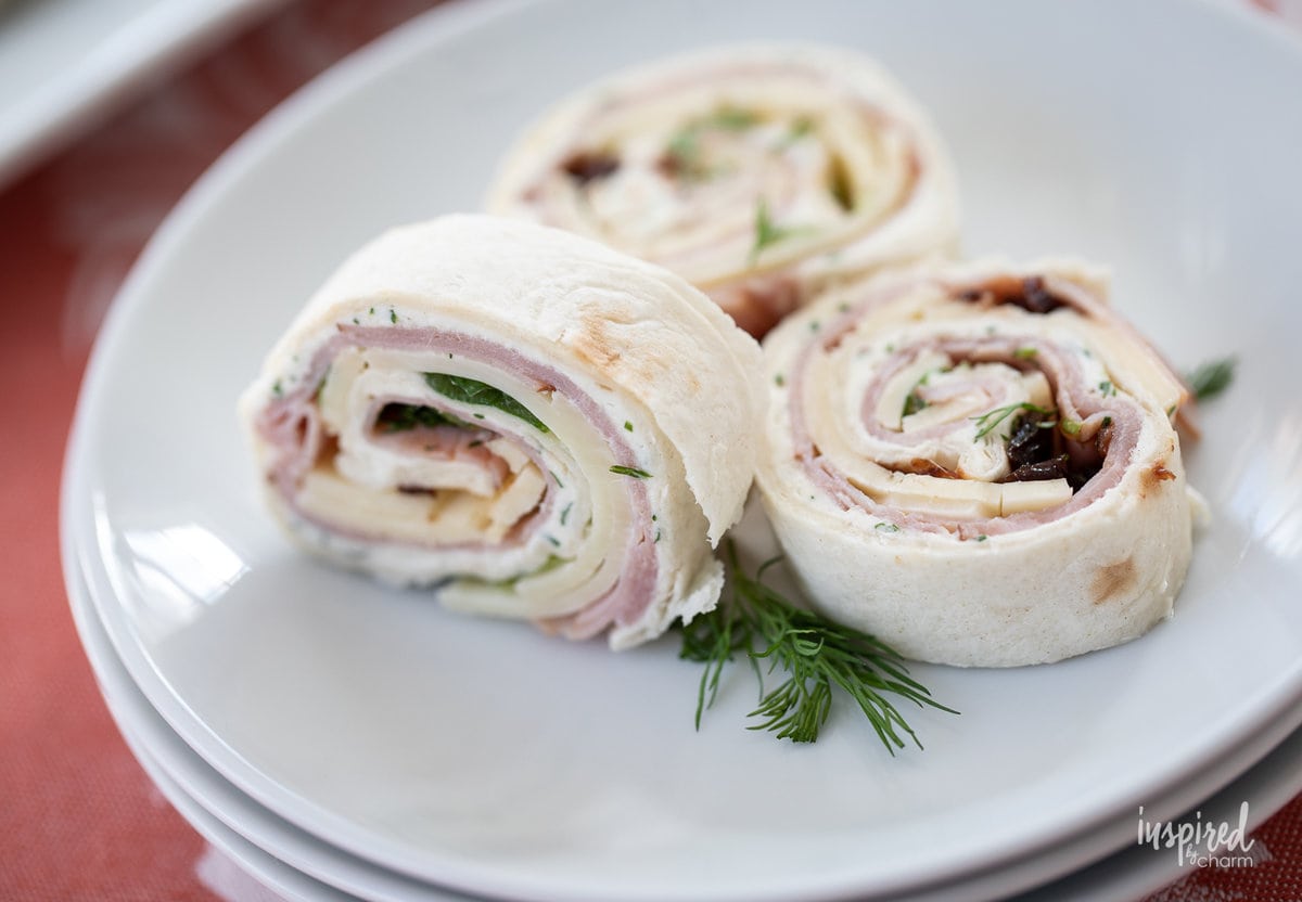 black forest ham pinwheels on a plate.