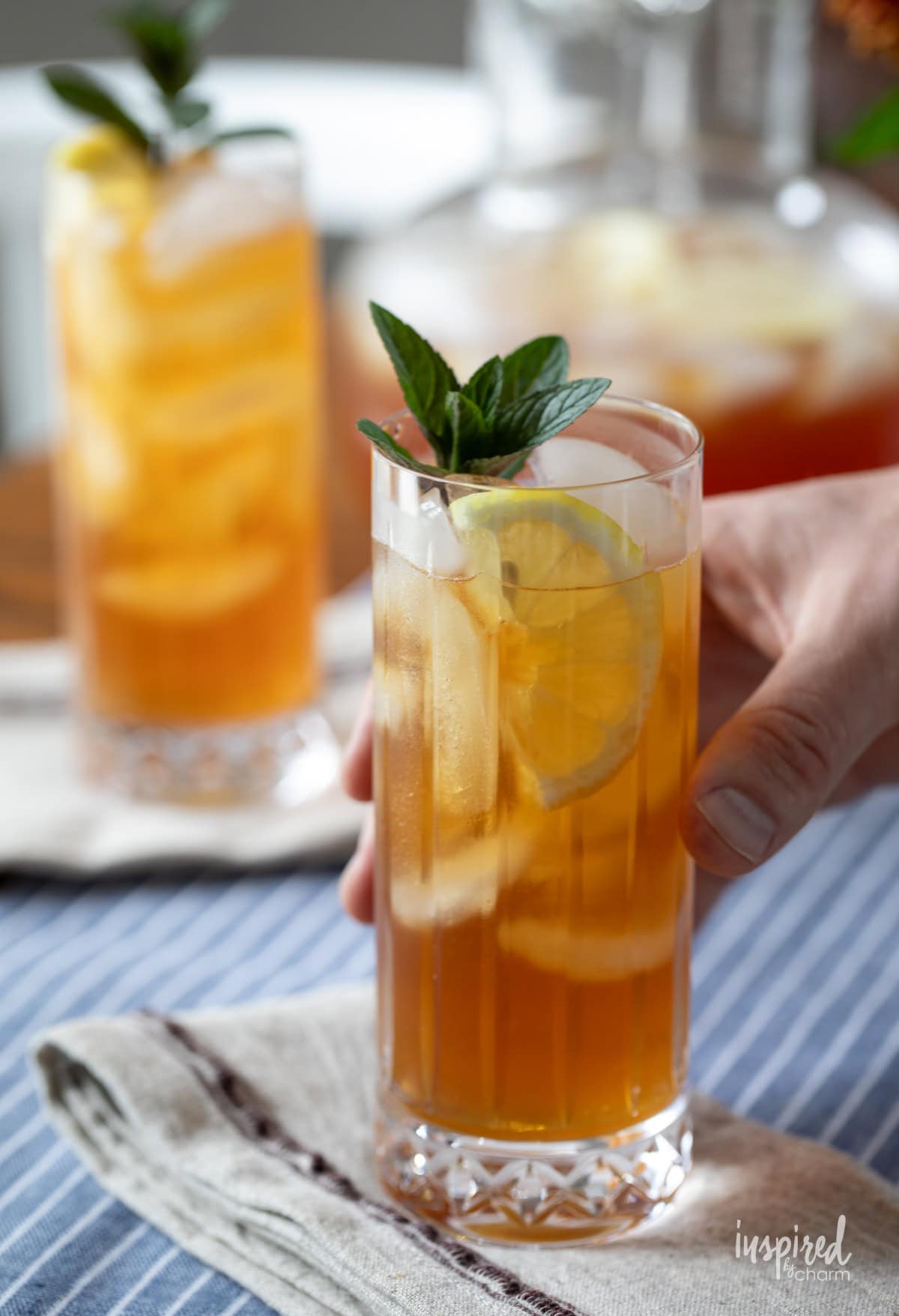 hand holding Arnold Palmer cocktail.