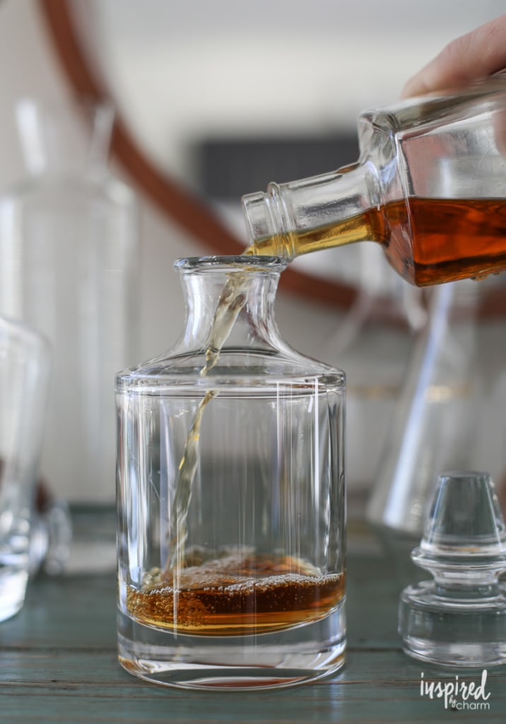 Bourbon and Whisky - Best Bourbon Cocktails adding bourbon to a decanter. 