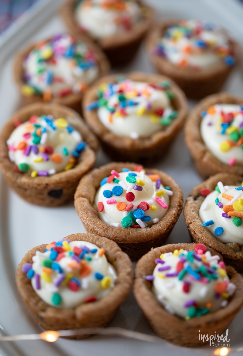 cheesecake cookie cups with rainbow sprinkles on a platter.