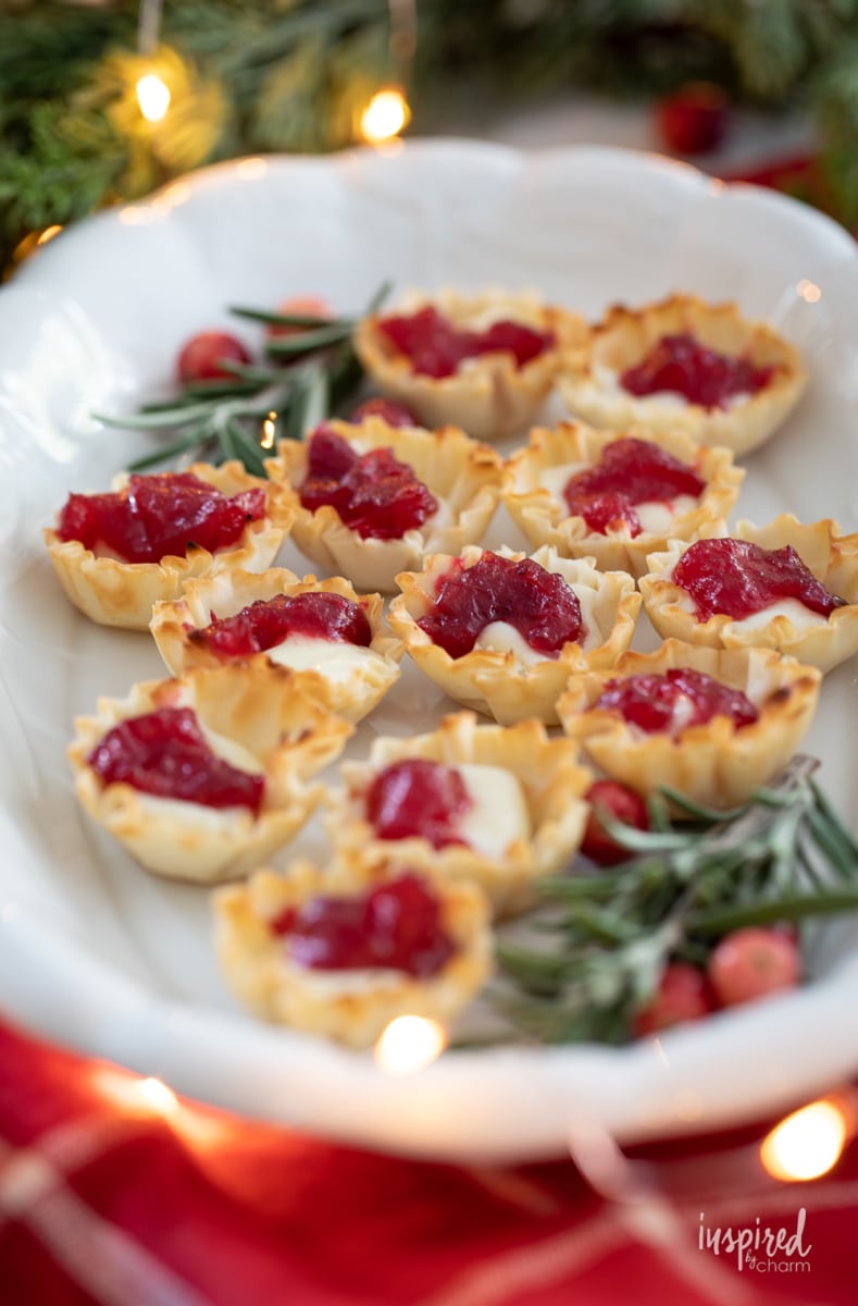 Cranberry Brie Bites on a platter with rosemary.