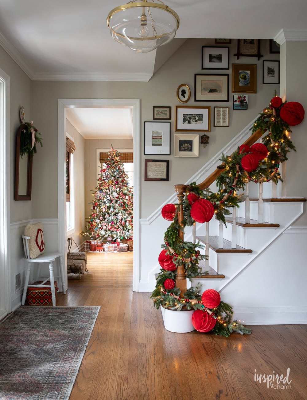 grand entrway christmas decor and tree in the background.