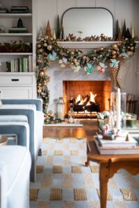 living room with christmas decor, fireplace, mantel.
