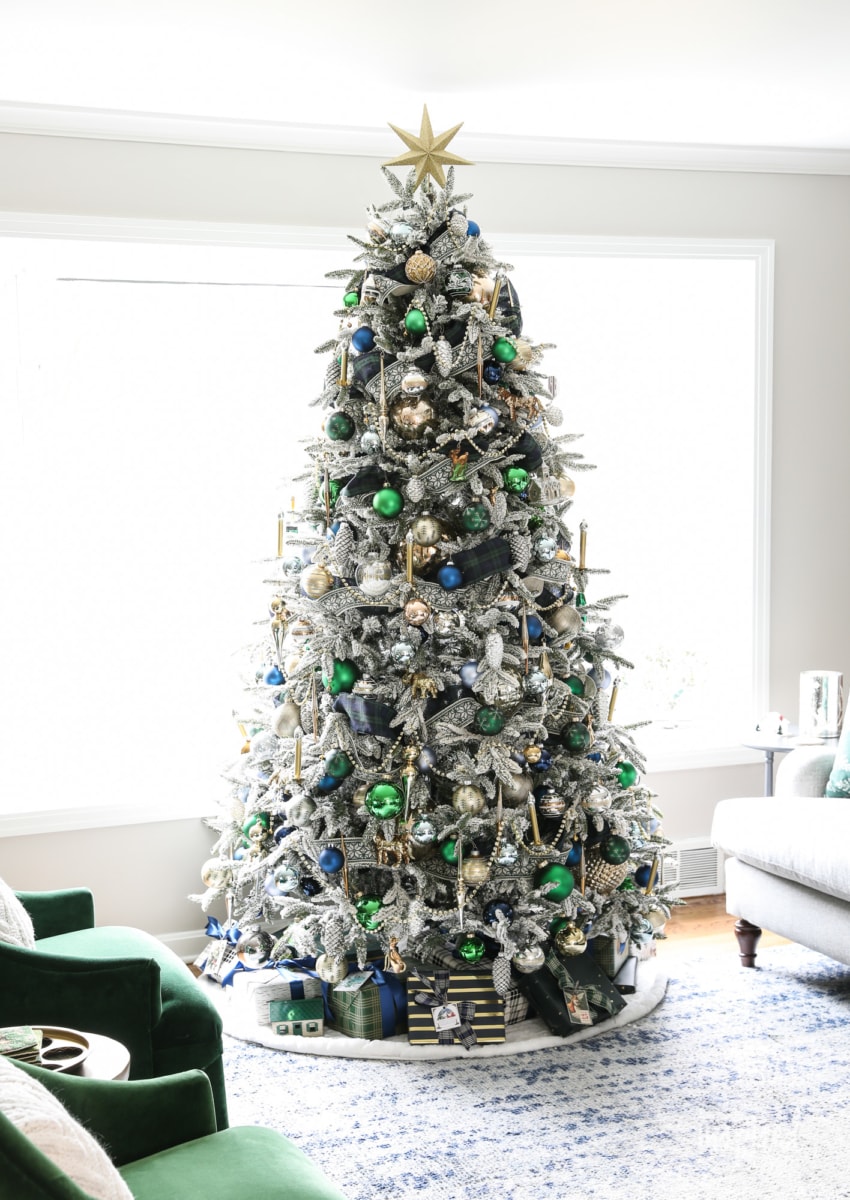 flocked tree with green and navy bulbs and gold bead garland