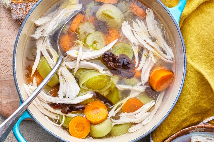 Broth soup with chicken, leeks and prunes