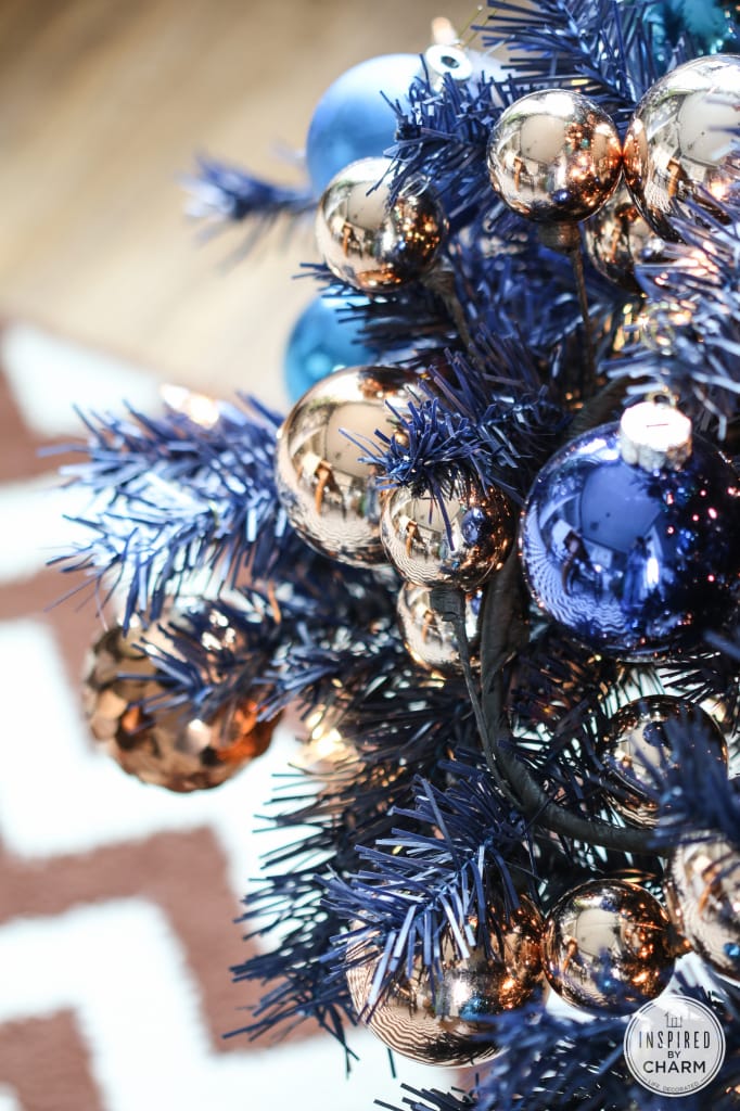copper bulb garland on a blue foil tree