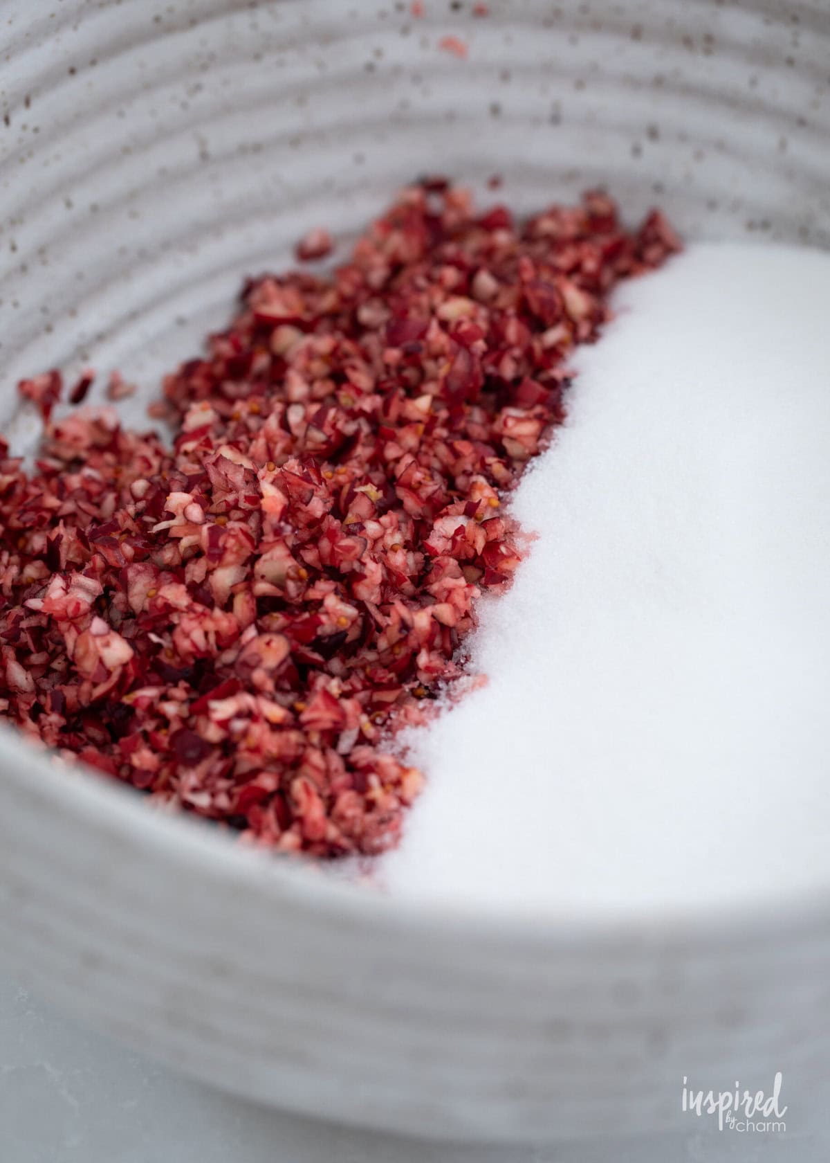 finely chopped cranberries in a bowl with sugar.