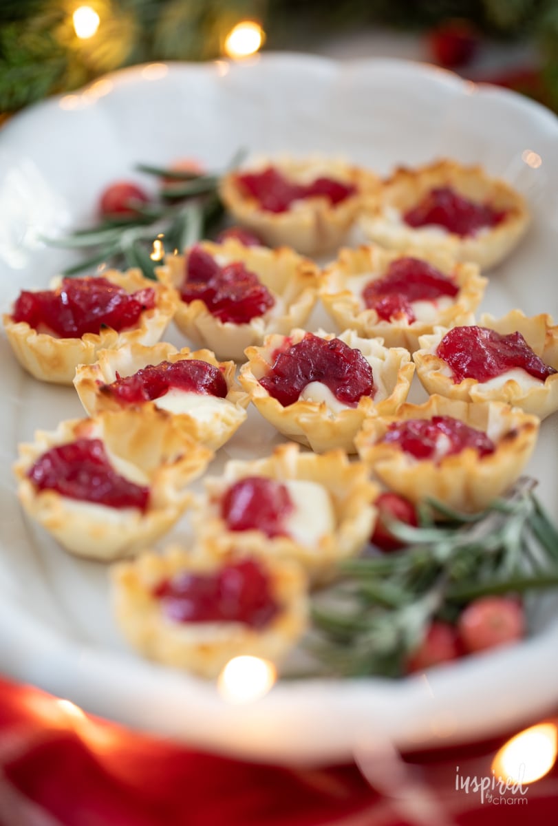 Cranberry Brie Bites on a platter with rosemary.