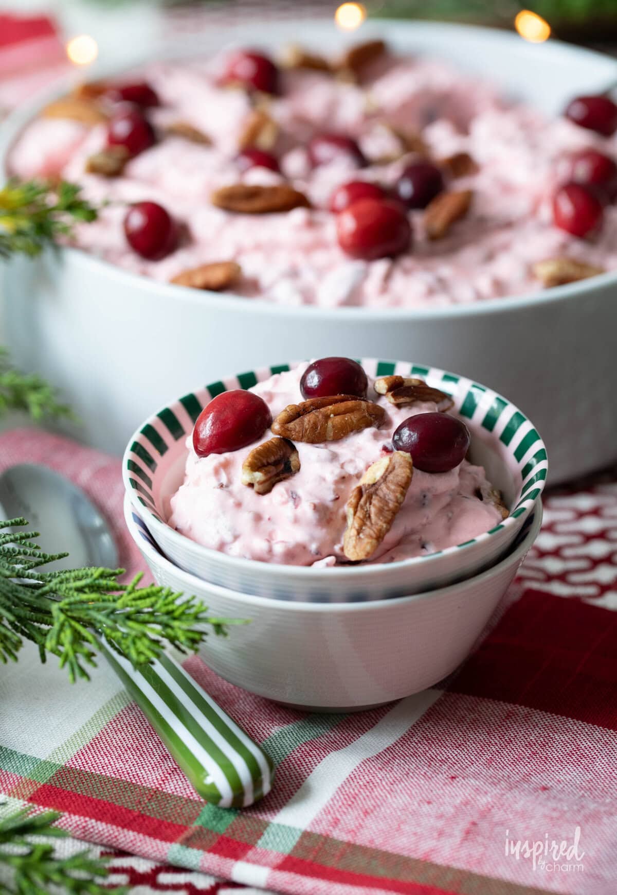 cranberry fluff salad served in a small dish with a spoon. 