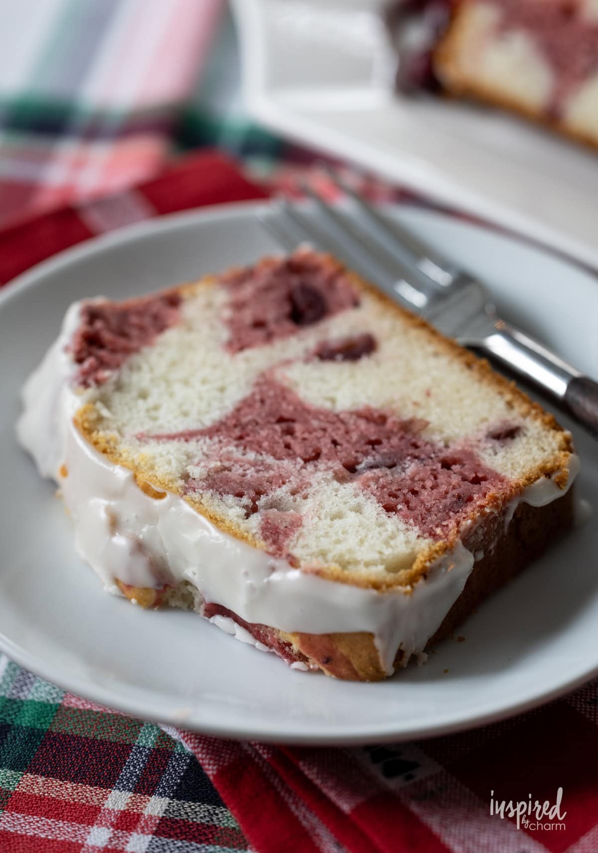 slice of Cranberry Marble Loaf Cake on a plate with a fork.