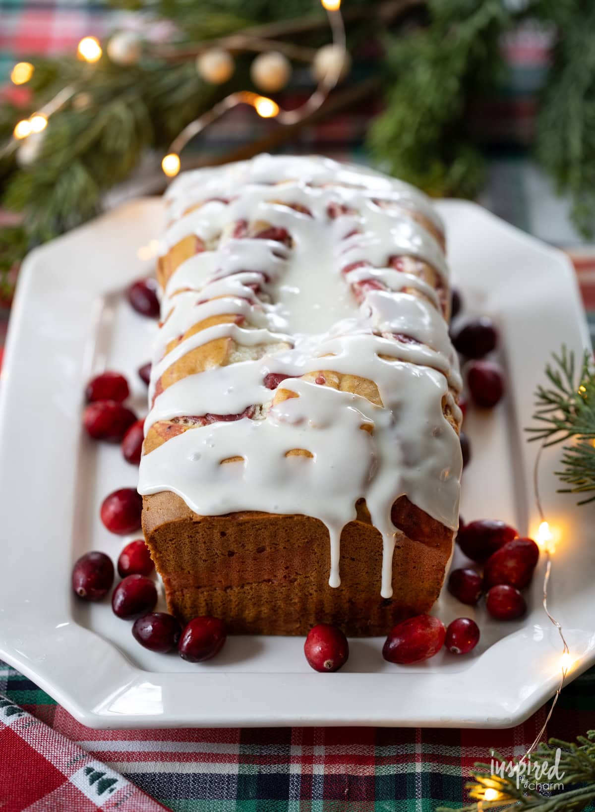 loaf of Cranberry Marble cake on a plate on a festive table.