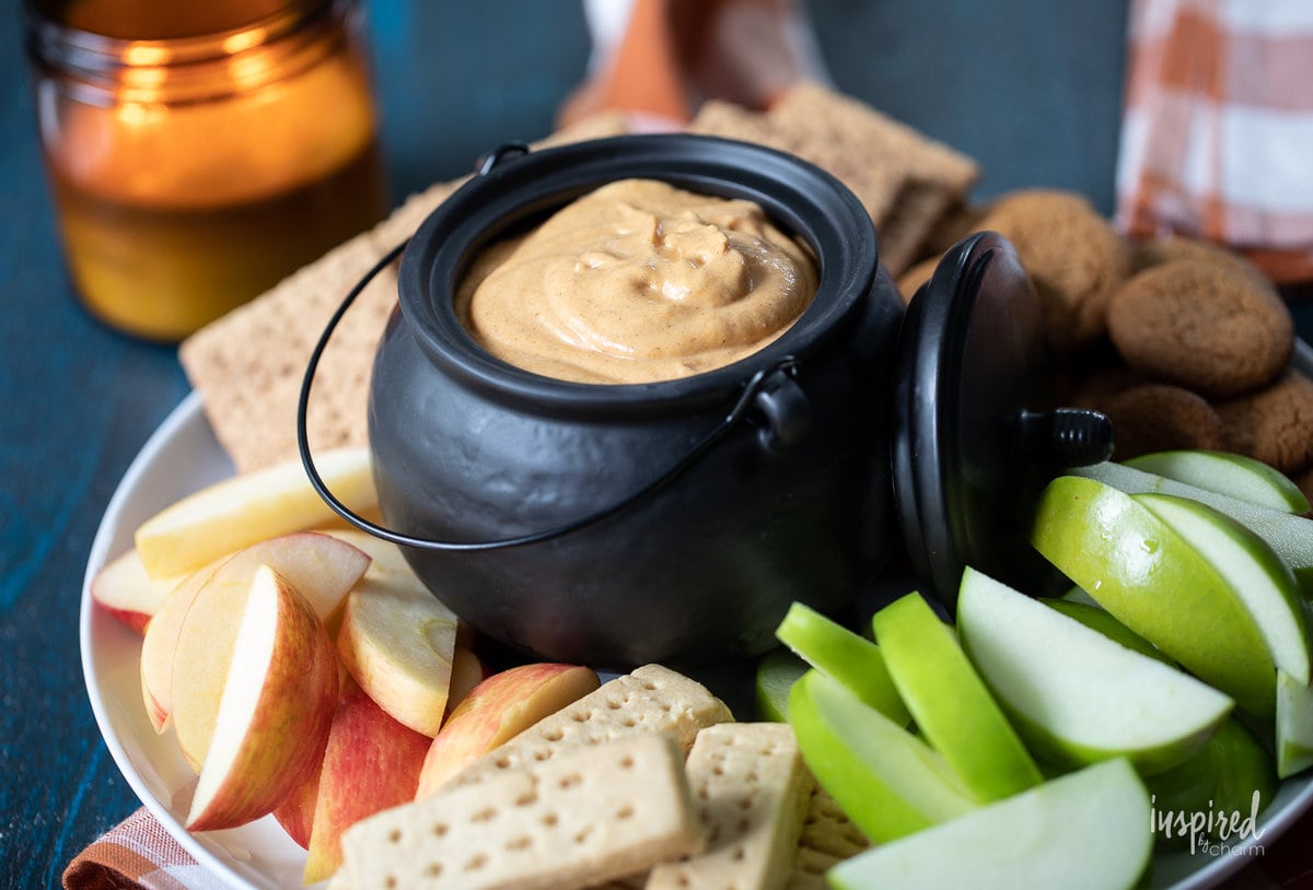 pumpkin dip in bowl with apples and cookies.