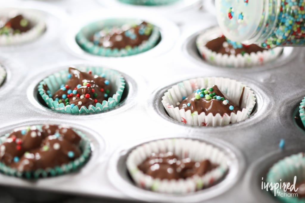 adding crockpot candy to baking cups.