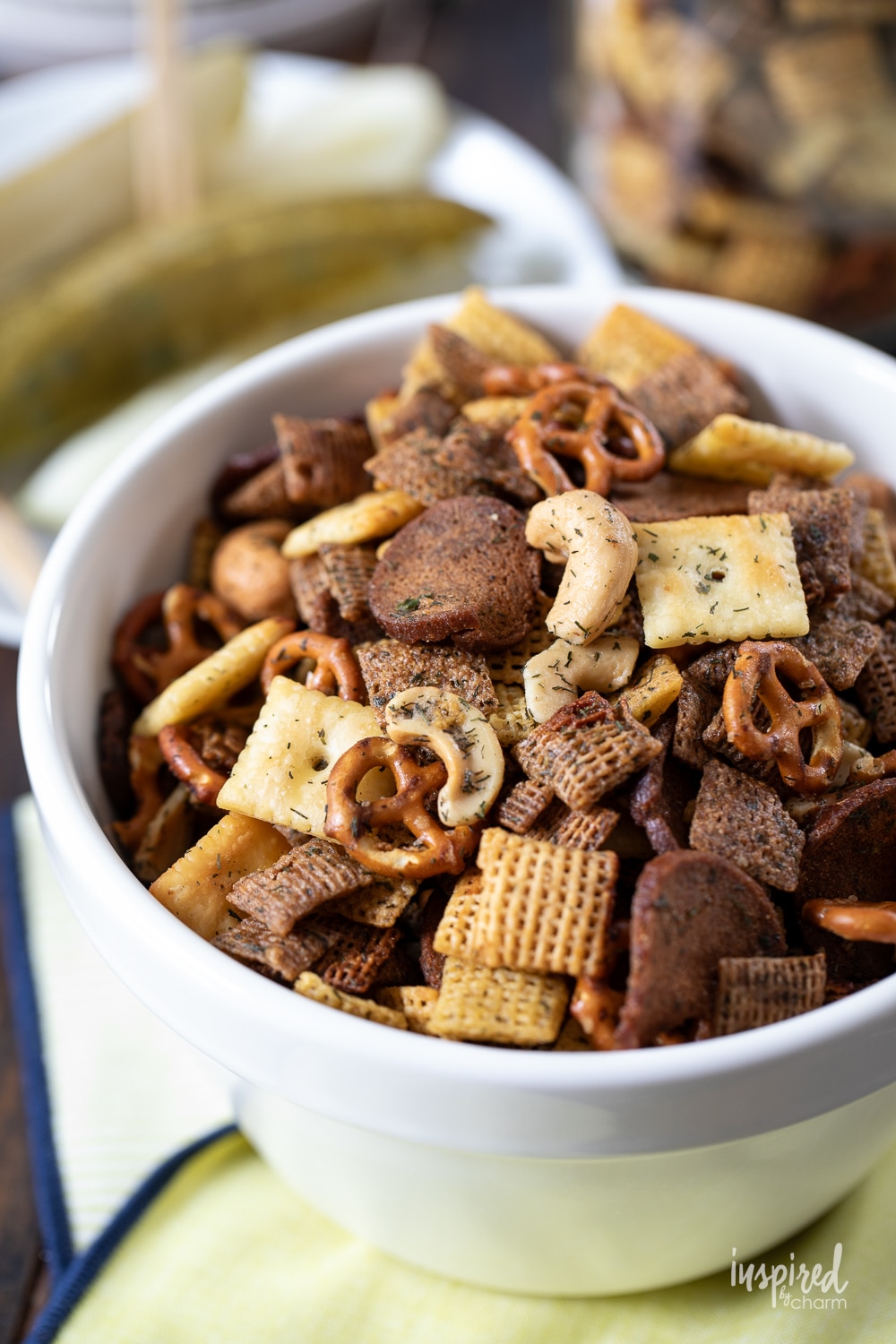 small white bowl filled with dill pickle snack mix.
