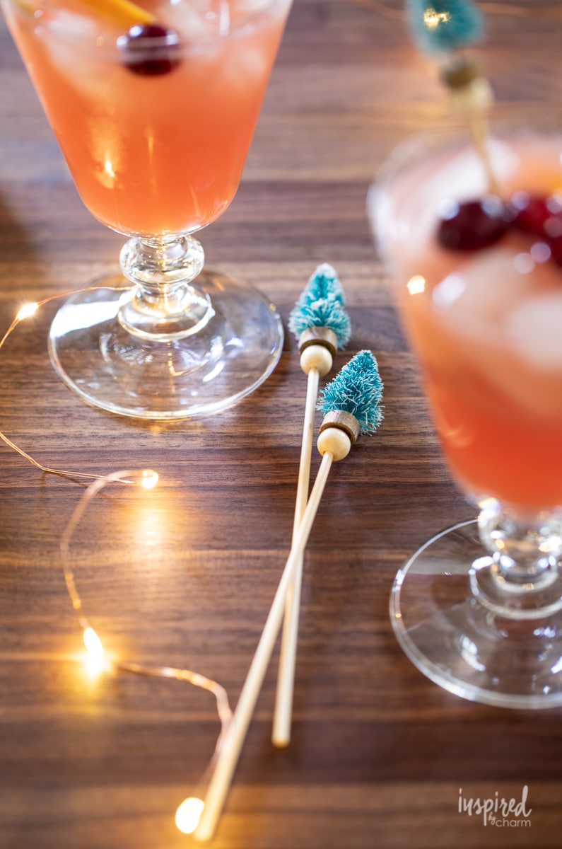 DIY christmas tree cocktail stirrers next to cocktails