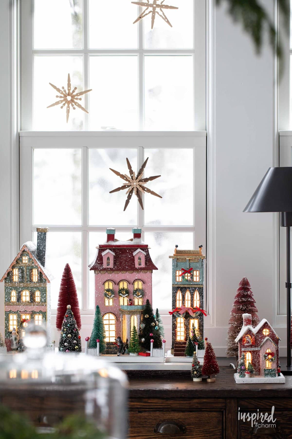 Clothespin Snowflakes hung above a Christmas village.