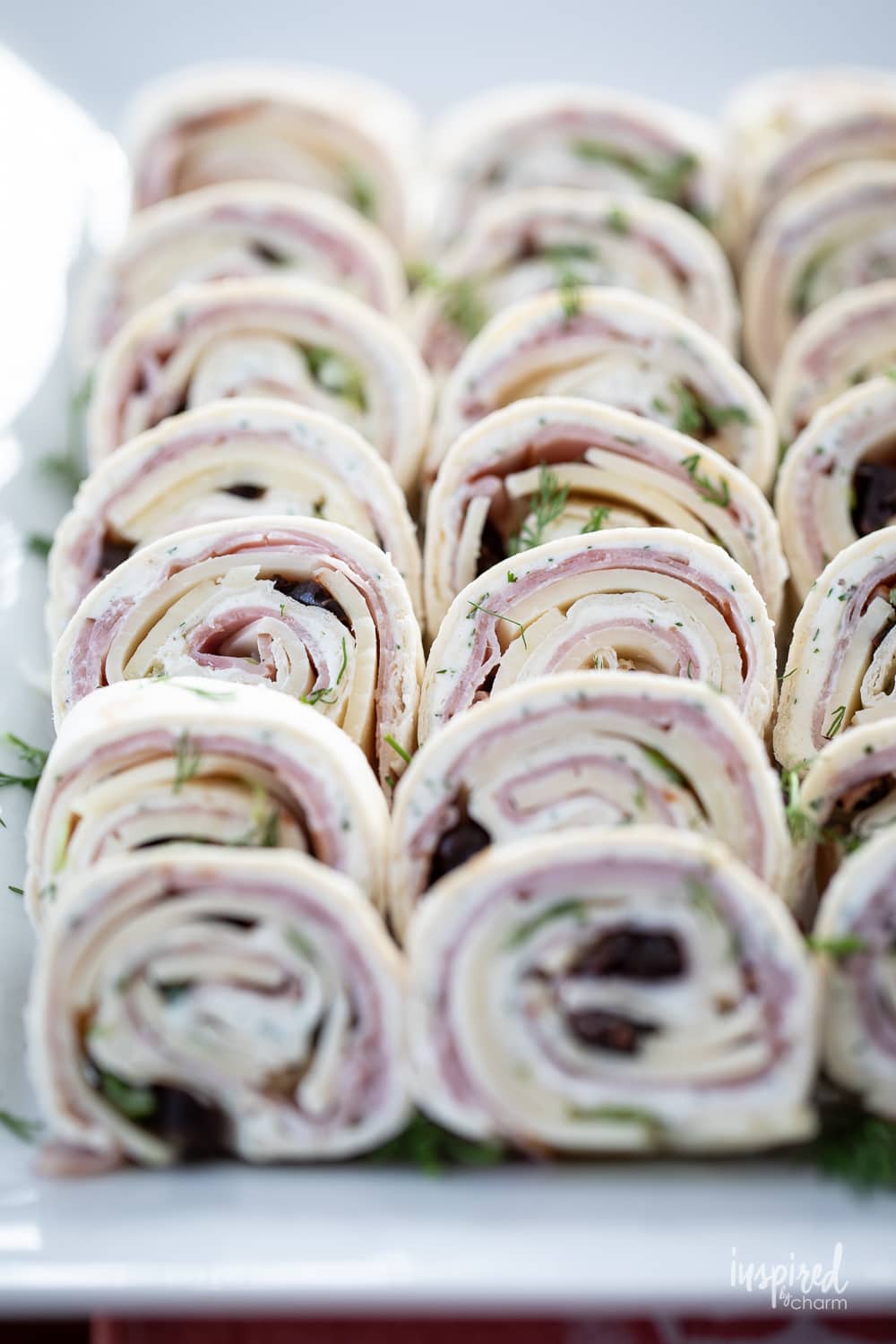 black forest ham pinwheels on a platter.