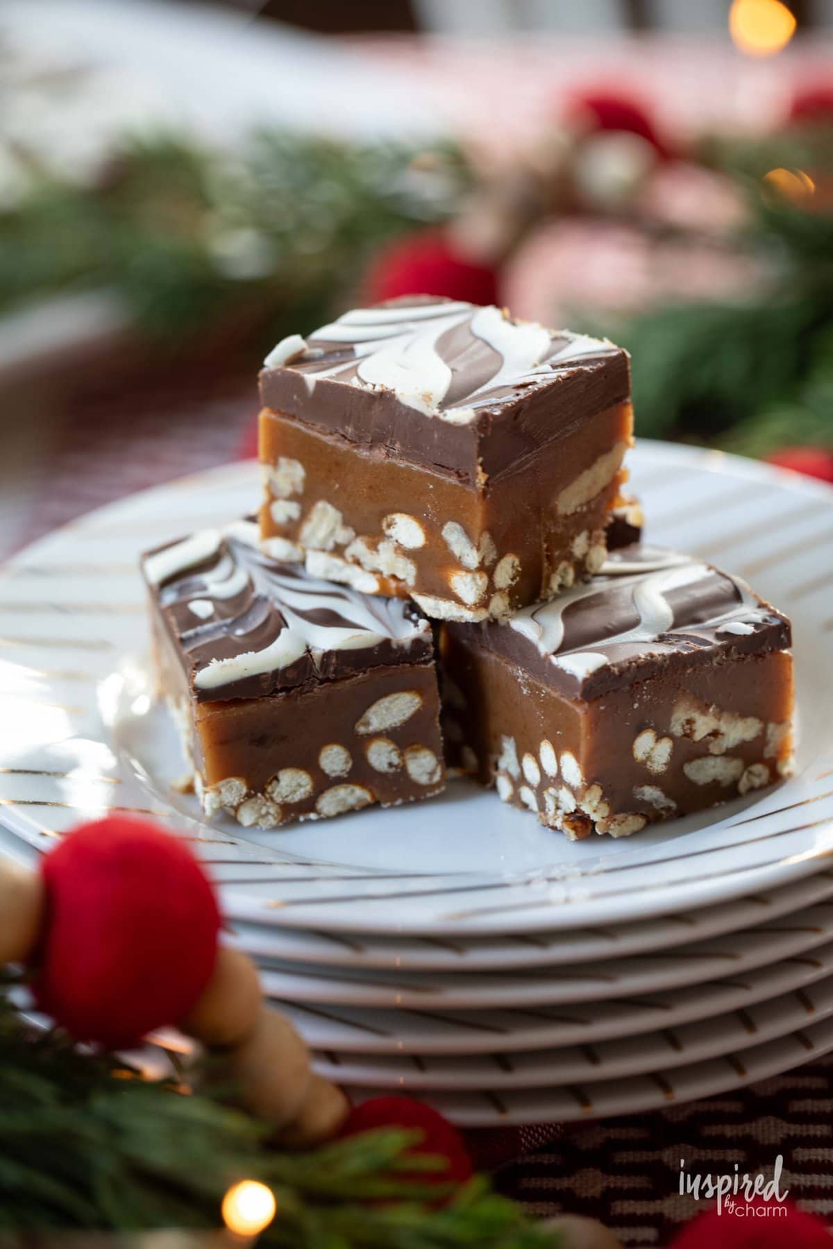 Caramel Pretzel Squares stacked on a stack of plates.