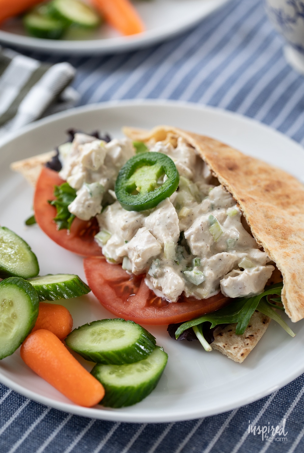 pita filled with Jalapeño Honey Chicken Salad served on a plate.