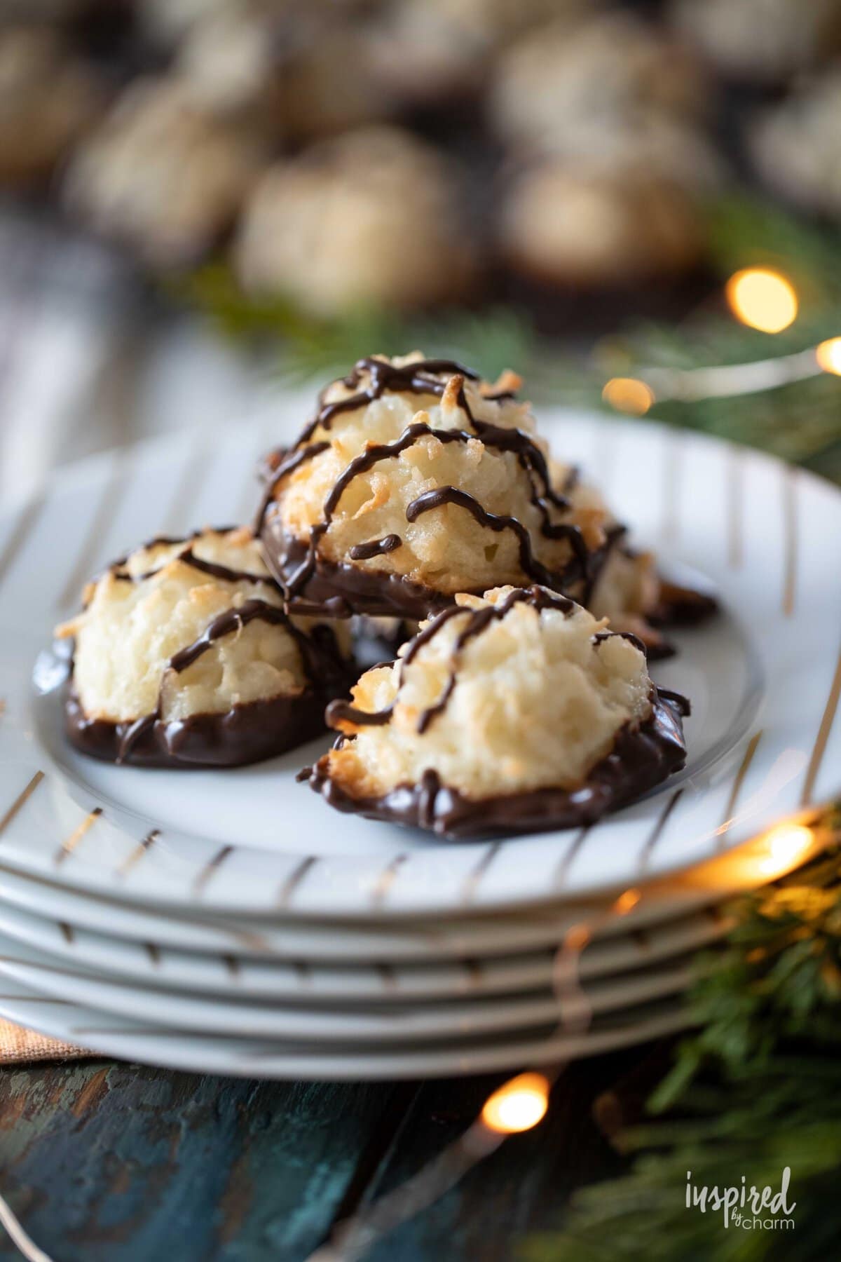 coconut macaroons with chocolate stacked on plates.