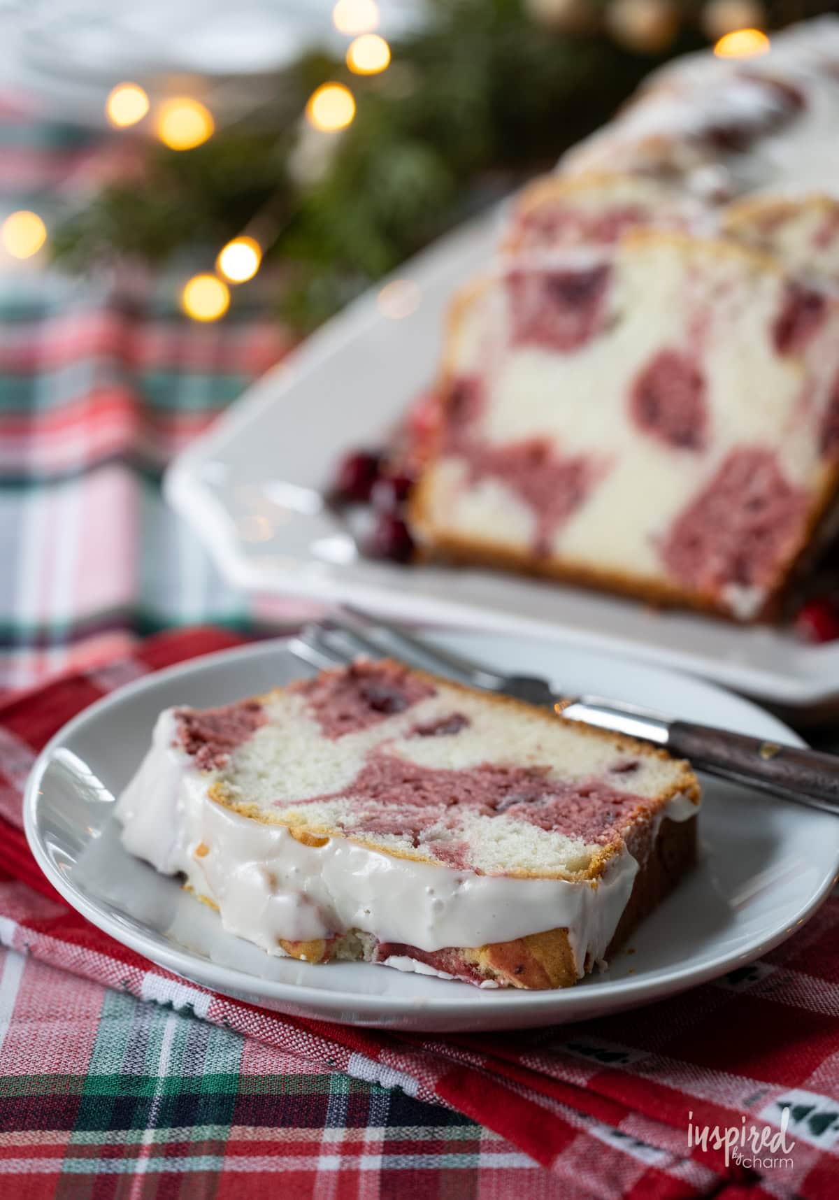 sliced Cranberry Marble Loaf Cake with a piece served on a plate with a fork.