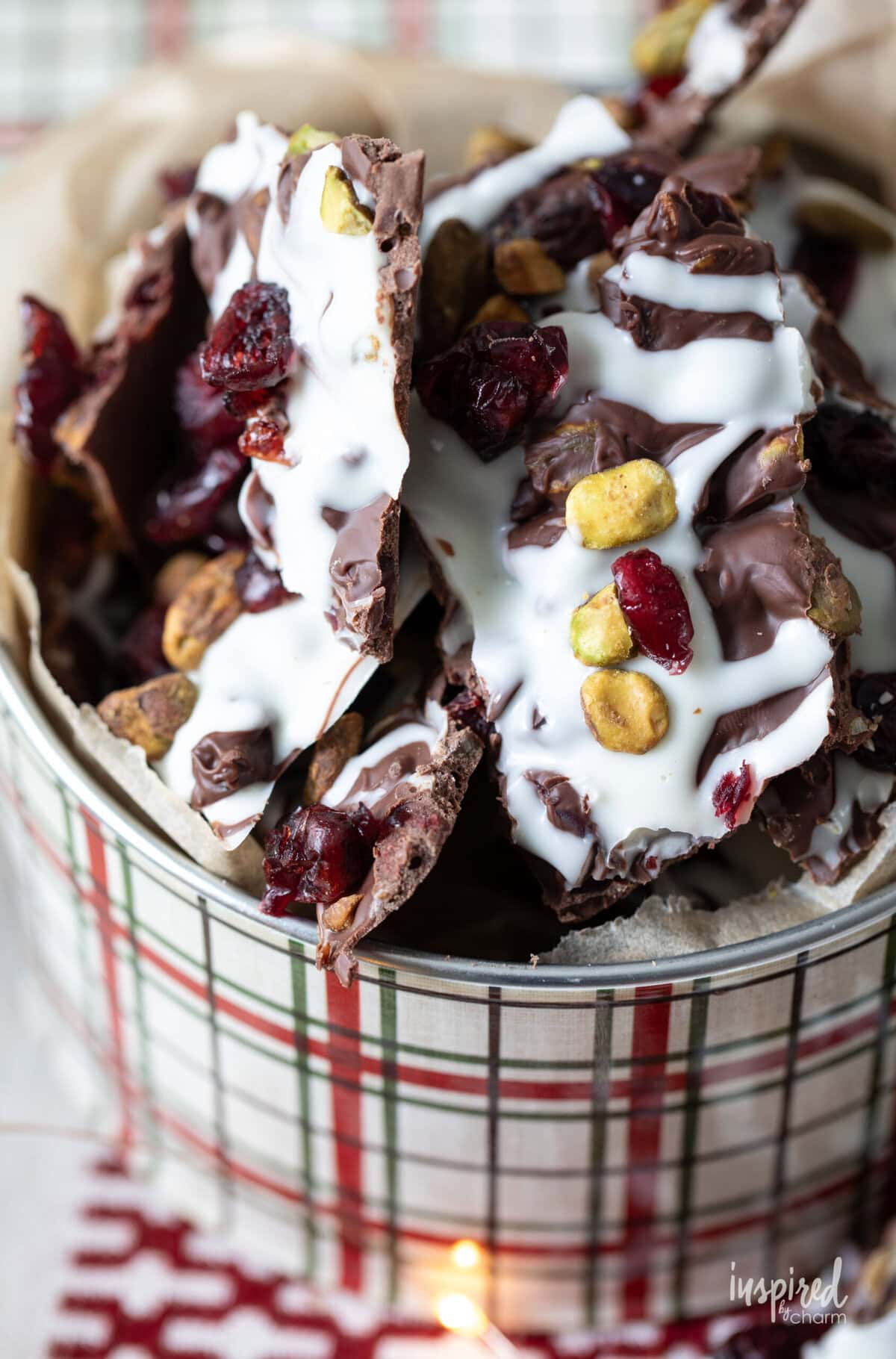 Cranberry Pistachio Bark pieces in a round tin.