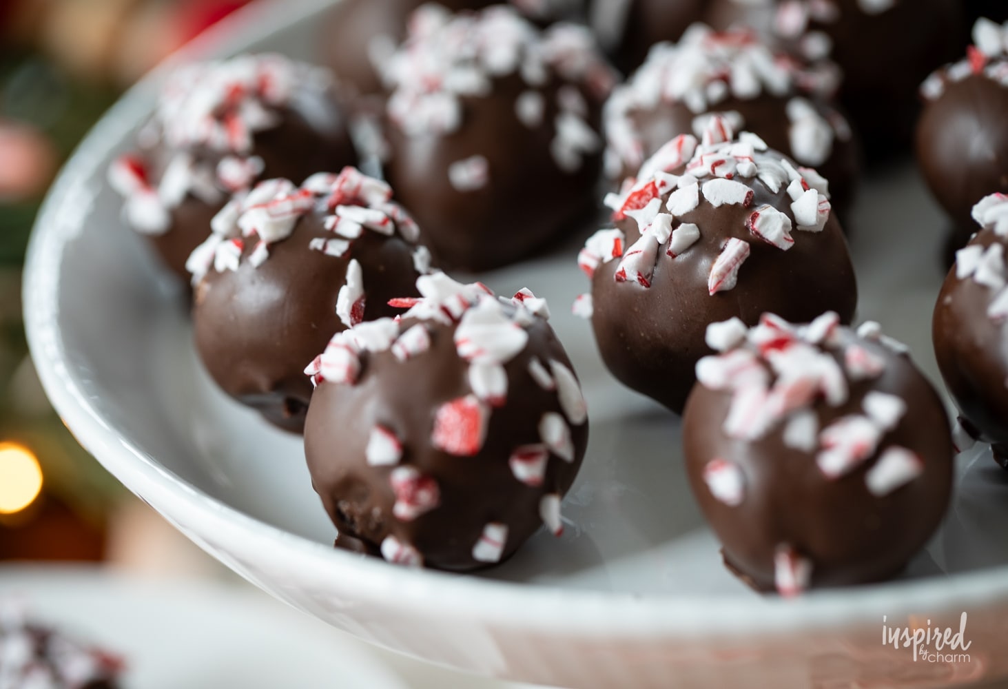 peppermint Oreo truffles served on a white cake plate.