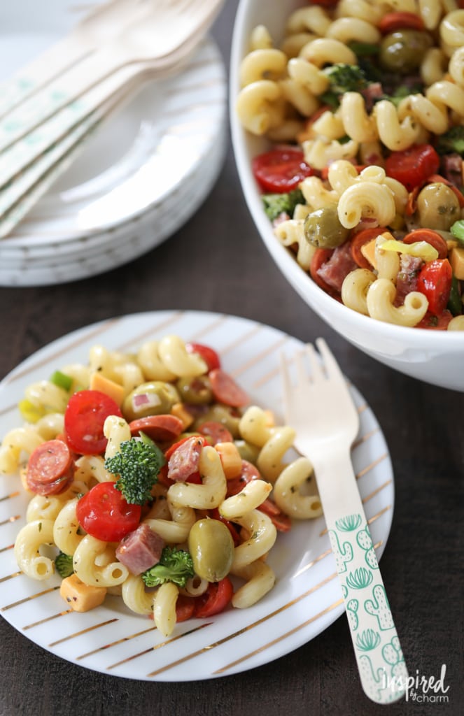 pasta salad in a bowl and served on a small plate with a fork.