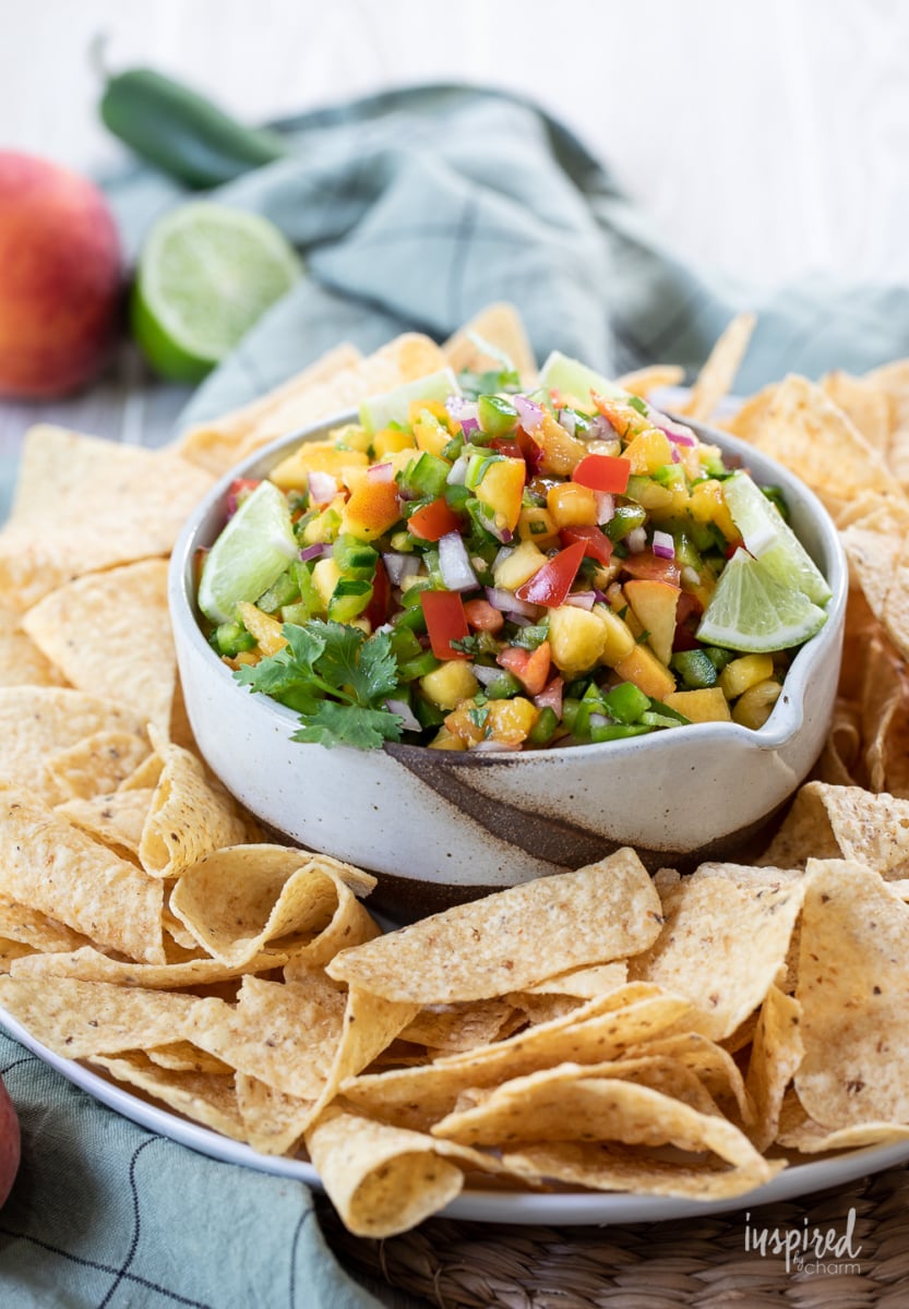 Spicy Peach Salsa in a bowl with tortilla chips.