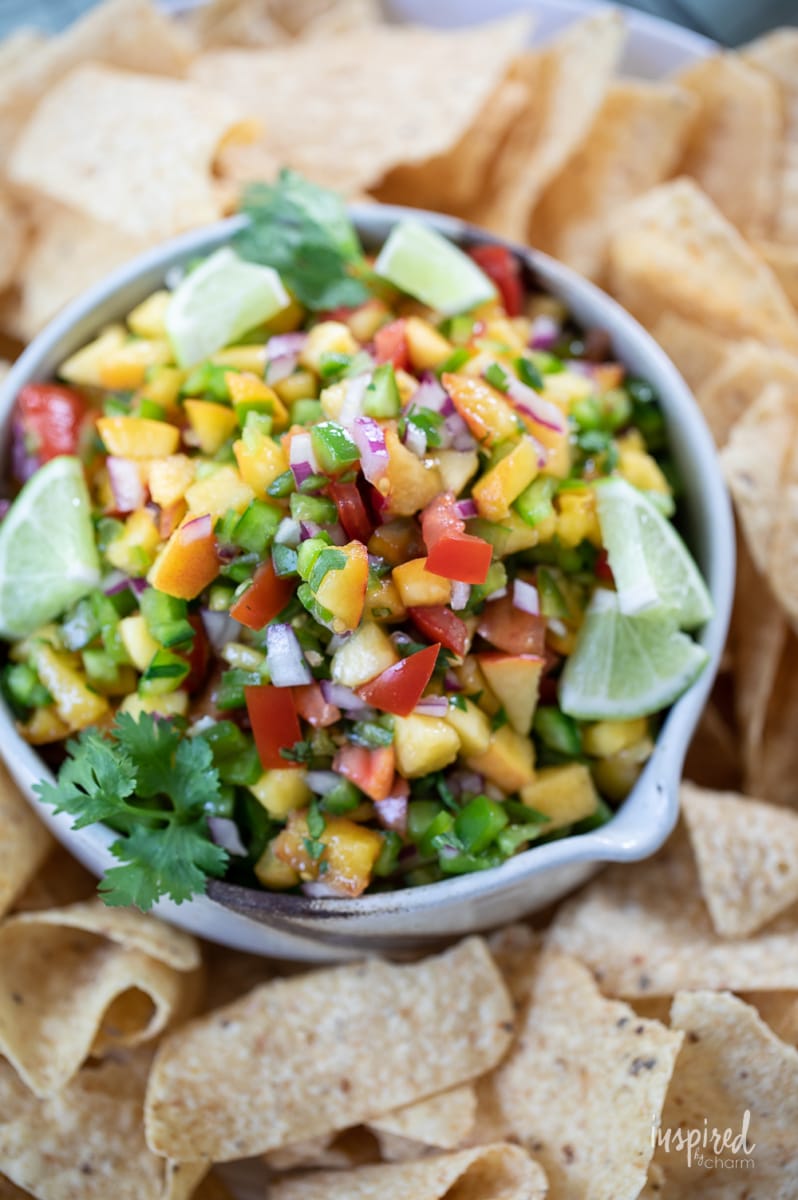 Spicy Peach Salsa in a bowl with tortilla chips.