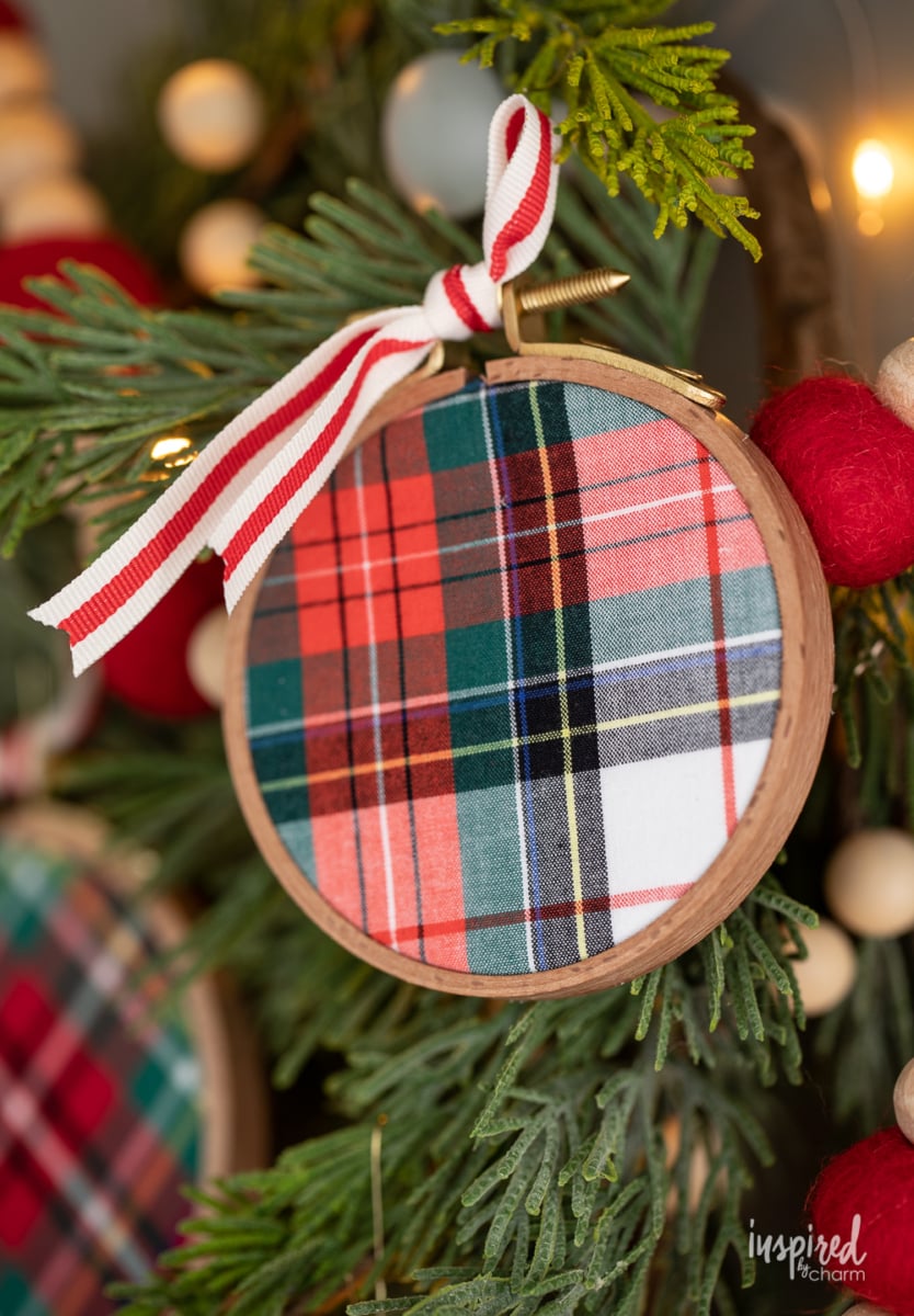 DIY Embroidery Hoop Christmas Ornaments on pine with lights and felt garland.