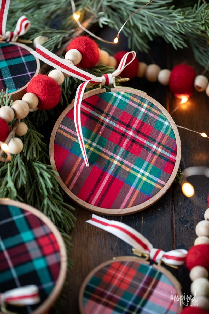 DIY Embroidery Hoop Christmas Ornaments on pine with lights and felt garland.