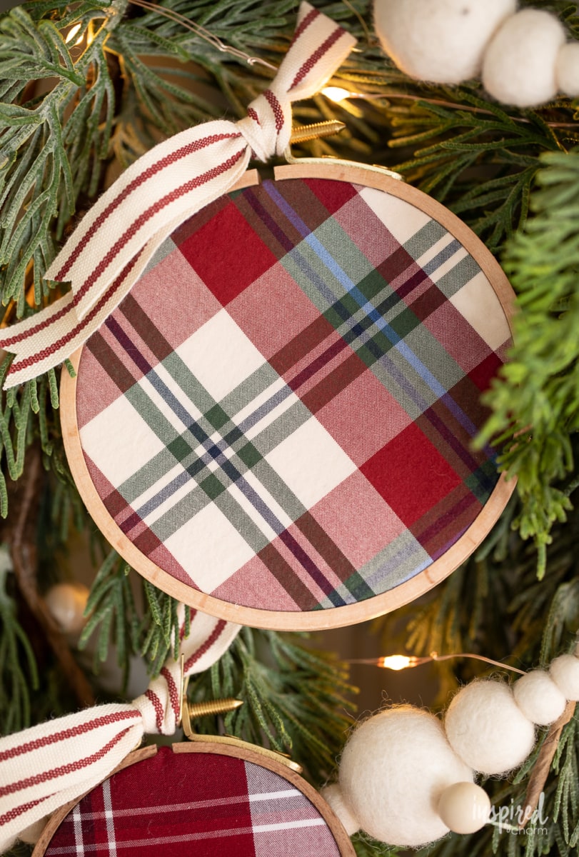 DIY Embroidery Hoop Christmas Ornaments on pine with lights and felt garland.
