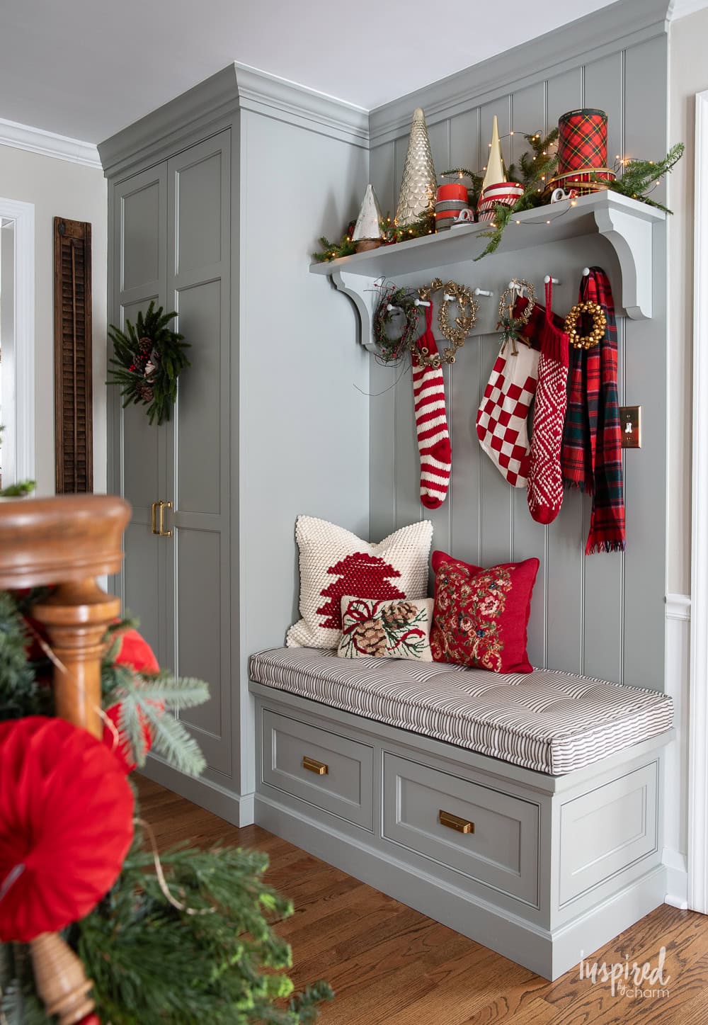 entryway built in closet shelves an bench decorated for Christmas.