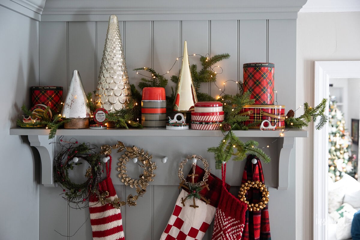 shelf with christmas decor new and vintage with vintage scotch tape tins.