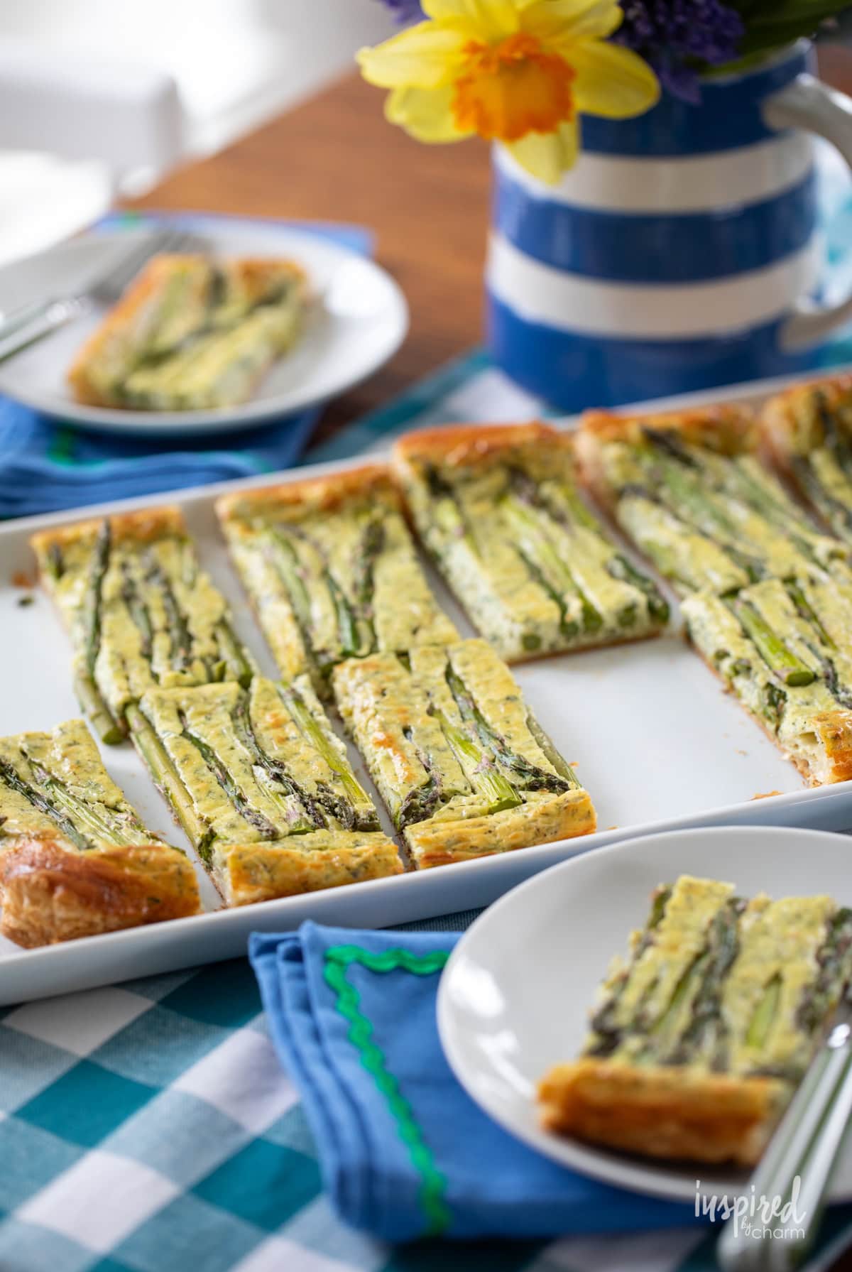 Goat Cheese and Asparagus Tart sliced and served on plates.