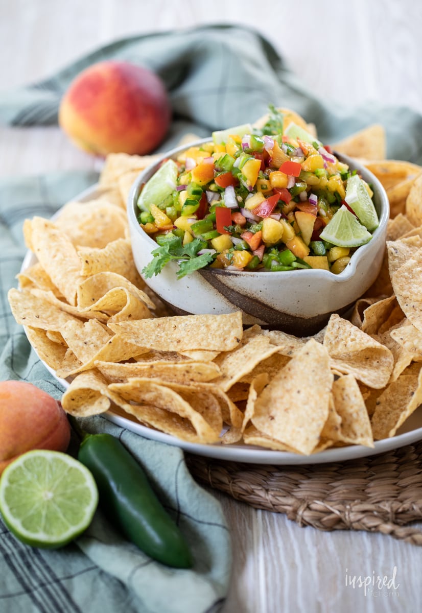 Spicy Peach Salsa in a bowl with tortilla chips.