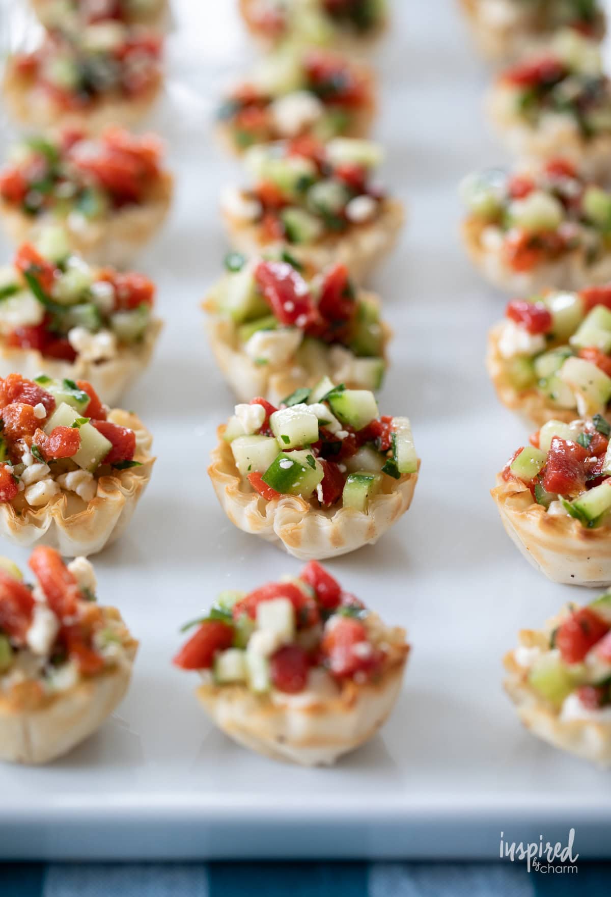 Greek Salad Phyllo Cups on a white platter.