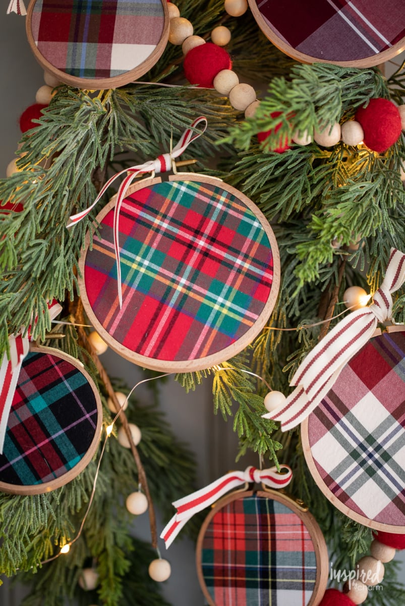 DIY Embroidery Hoop Christmas Ornaments on pine with lights and felt garland.