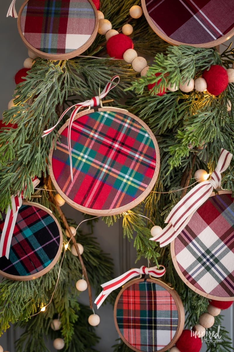 DIY Embroidery Hoop Christmas Ornaments on pine with lights and felt garland.