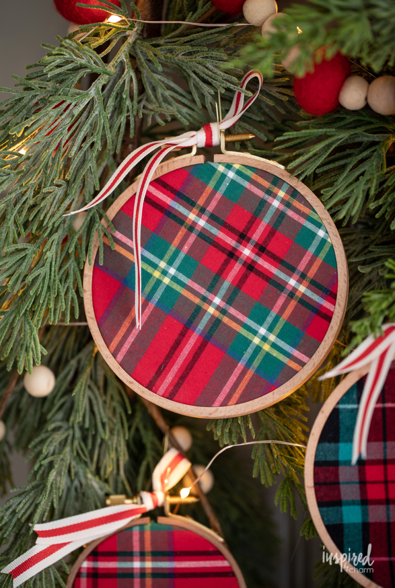 DIY Embroidery Hoop Christmas Ornaments on pine with lights and felt garland.